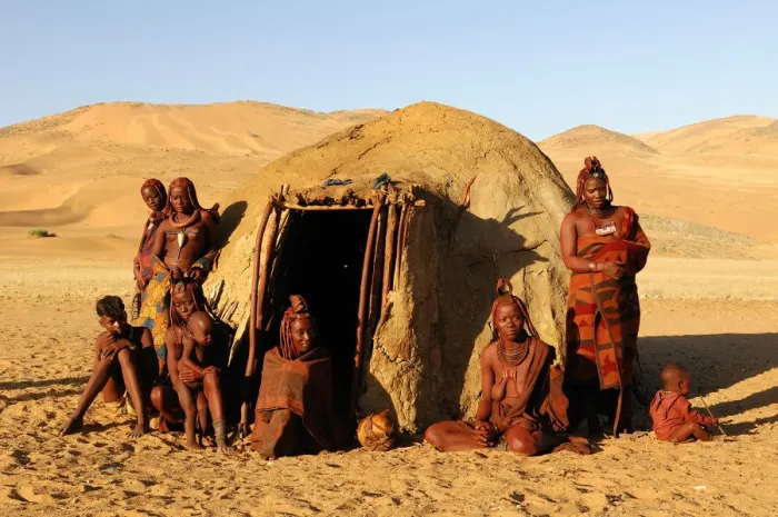 Framed Print : Namibia. Himba women at hut, village near Serra Cafema Wilderness Safaris at Kunene River